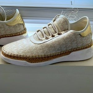 Michael Kors canvas/ tennis shoe. Beige with Kors emblem fabric design.
